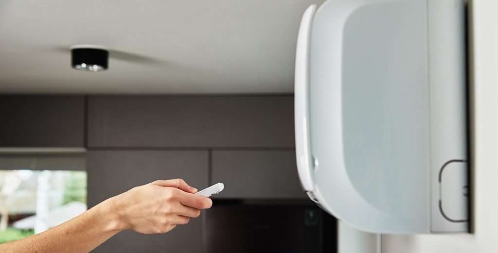 a person checking an air conditioner
